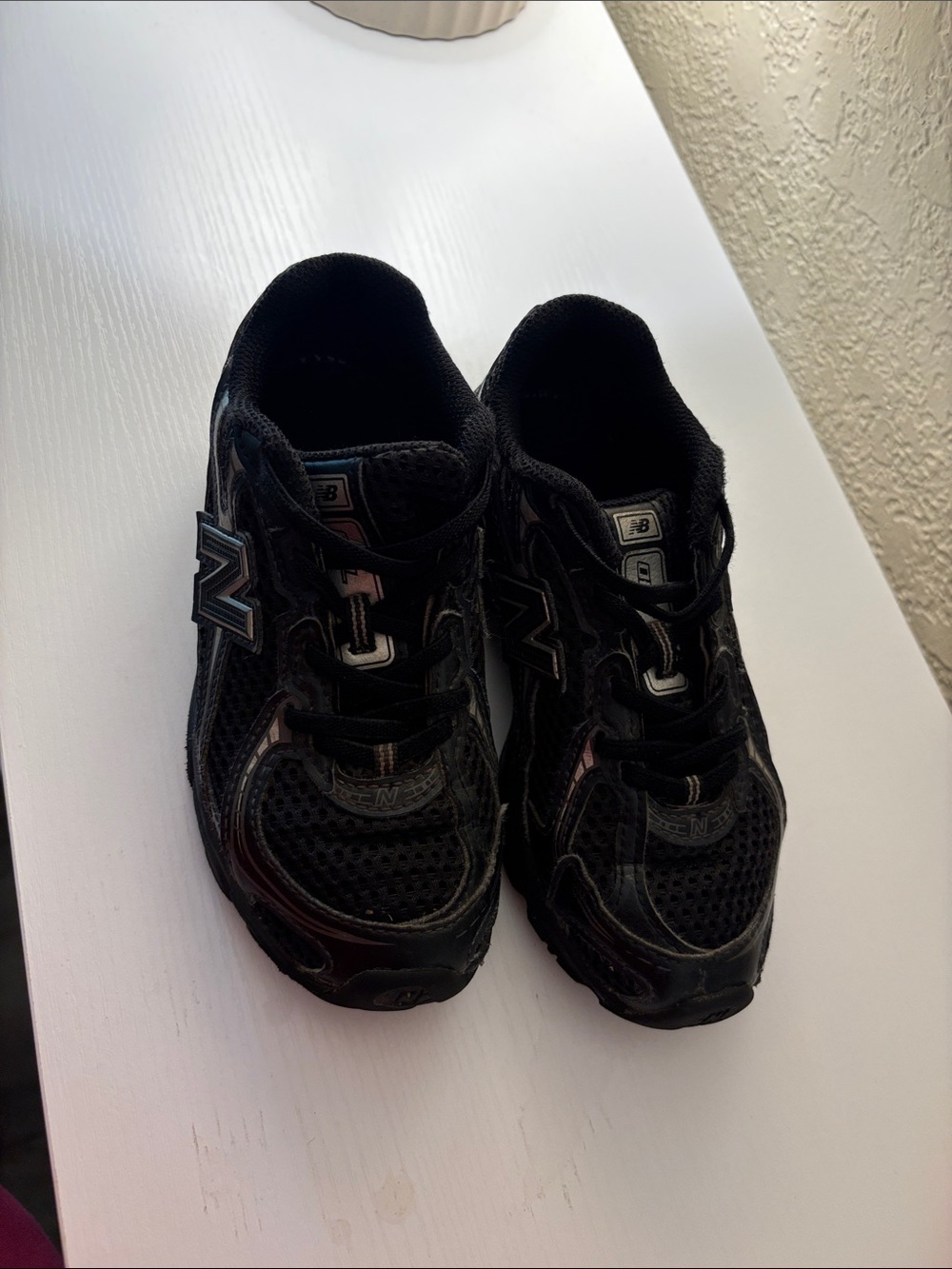 New Balance Kids Black Sneakers with Silver Accents